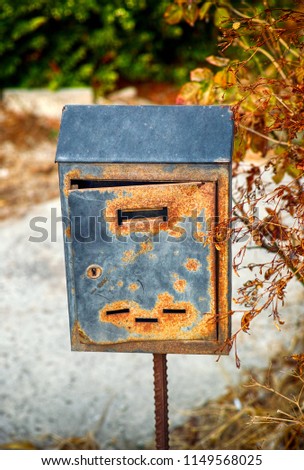 Old rusty mailbox outside. Close-up