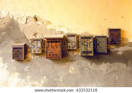 Old rusty mailboxes on the wall