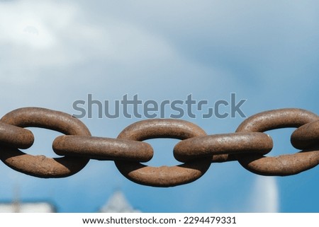 Old rusty metal chain outdoors. Large chain links.
