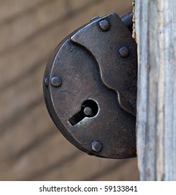 Old rusty metal lock of brown color. Closeup, macro.