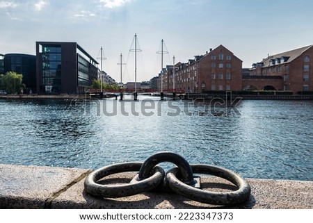 Old rusty metal moorage and the Circle Bridge (Cirkelbroen) in Christianshavn, Copenhagen, Denmark