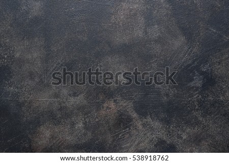 Old rusty metal pan.Black grunge background.