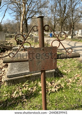 Old rusty metal tombstone in the public cemetery
