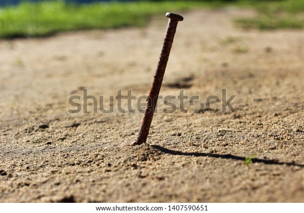 Old Rusty Nail Sticking Out Ground Stock Photo (Edit Now) 1407590651