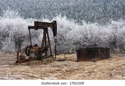 Old, Rusty Oil Well On A Winter Landscape