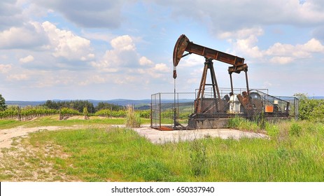 Old Rusty Oil Well On A Field