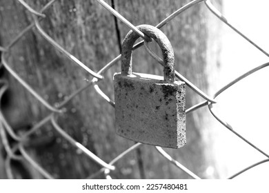 old rusty padlock on an iron fence close-up - Shutterstock ID 2257480481
