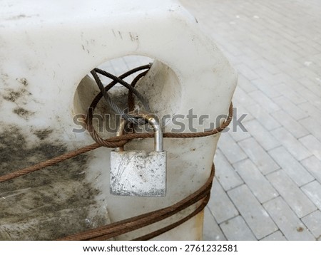 Old Rusty Padlock Wire Rope Locked White Concrete Urban Security Weathered Aged Outdoor
