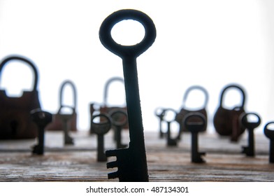 Old rusty padlocks and keys on white wooden table