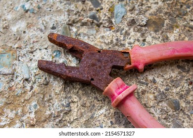 Old Rusty Pliers. Closeup Photo Of Aged Red Pliers.