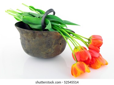 Old Rusty A Protective Helmet   Of The Unknown  Soldier Of The Second World War And Tulips. Memories Concept. Isolated On White.