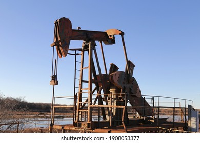 Old Rusty Pump Jack In The Oilfield In Texas