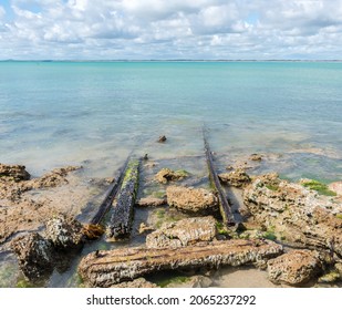 Old Rusty Rails Leading Into The Beach And Blue Waters Of Guichen Bay, On The Limestone Coast At Robe, South Australia