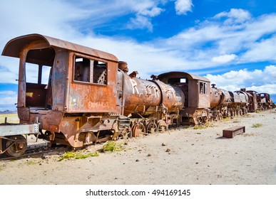 Old rusty railway carriage with graffiti in Train cemetery in Uyuni desert, Bolivia with blue sky and soft focus - Shutterstock ID 494169145