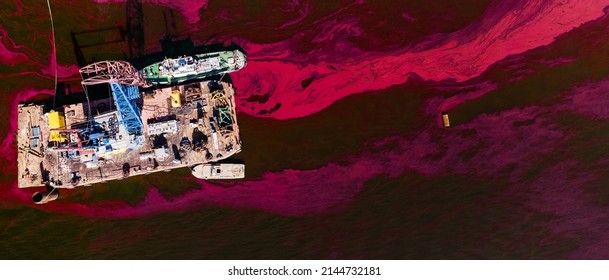 An Old Rusty Red And Brown Barge In Red Water. Urban And Industrial Decay Concept.