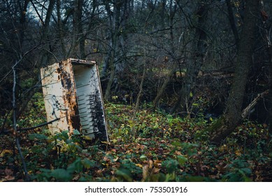 An Old Rusty Refrigerator Is In The Woods