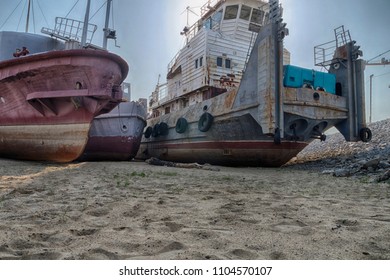 Old rusty and rumpled river tug with some other boats and ships near by. HDR image