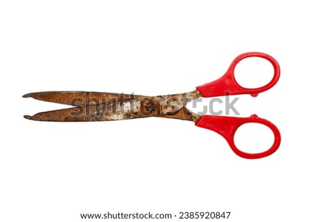 Old rusty scissors on white background. Old scissors with red plastic handles.