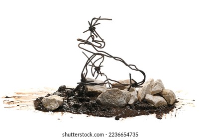 Old rusty security barbed wire fence and stones in wet mud isolated on white