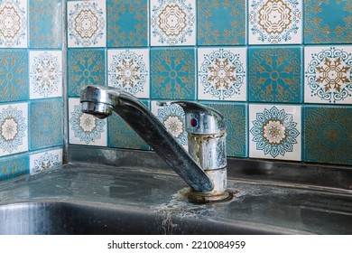 Old Rusty Sink Faucet In Kitchen. Rust Streaks, Calcium Scale, Hard Water. Concept Of Poor Water Quality.