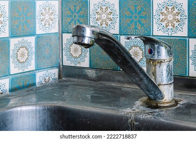 Old Rusty Sink Faucet In Kitchen. Rust Streaks, Calcium Scale, Hard Water. Concept Of Poor Water Quality.