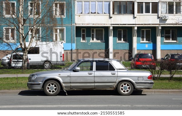 Old rusty Soviet car on\
the street, Iskrovsky Prospekt, Saint Petersburg, Russia, April\
2022