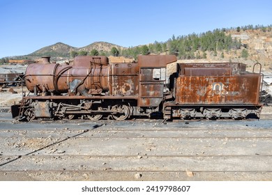 Old and rusty steam mining train used for transportation of the copper of  Corta Atalaya mining exploitation with the port of Huelva. Remains of the old copper mining operation in Minas de Riotinto