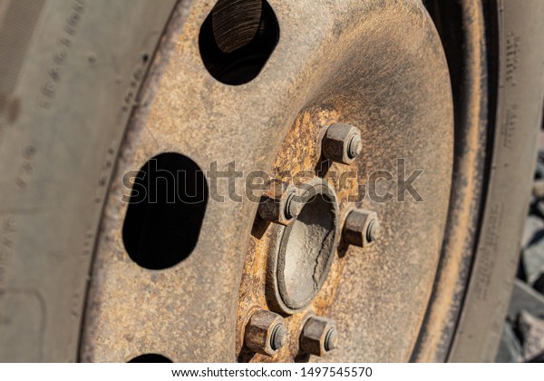 Old rusty steel\
auto wheel disc, car\
service.