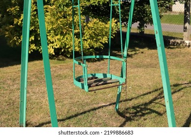 Old rusty steel swing from the 1980s - Shutterstock ID 2199886683