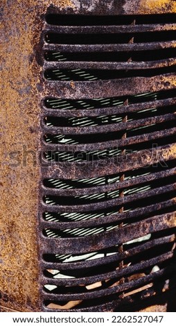 An old rusty tractor grill