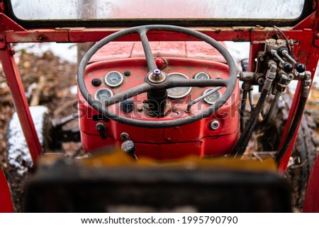Old rusty tractor interior in woods during winter, 135 Massey Ferguson