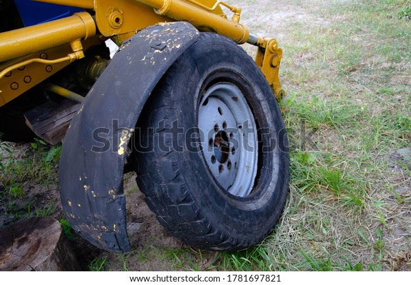 Old rusty\
tractor\'s flat back tire.\
industrial