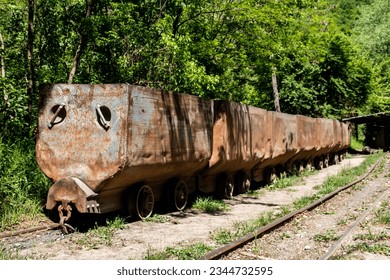 Old rusty train wagon forever parked at an abandoned railway station used for excavation of charcoal from underground mine, near Despotovac city, Serbia - Powered by Shutterstock