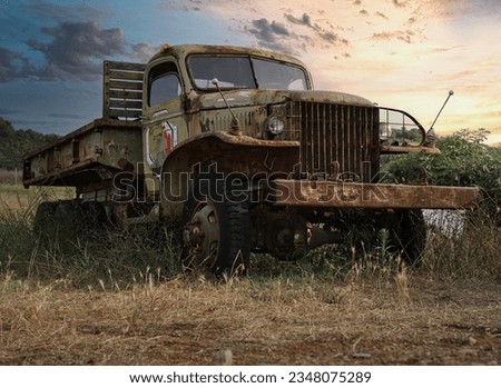 Old, Rusty, Transporter With Peeled Paint In The Field At Sunset