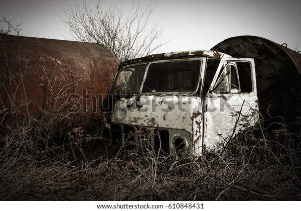 Old rusty truck cabins on\
the ruins of an unfinished nuclear power plant, Ukraine Odessa\
region.