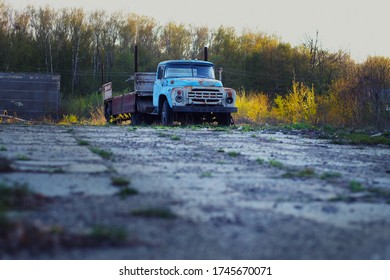 Old Rusty Truck Stands On A Derelict Site