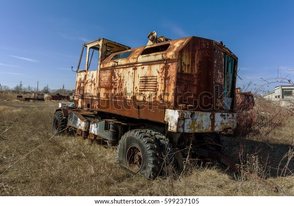 Old rusty truck thrown in desert of car park\
in ghost town of Pripyat, Chernobyl, Ukraine. Old rusty ancient\
car, Broken abandoned ancient rusty iron car. Radiation Zone\
Stalker, Apocalypse\
industrial