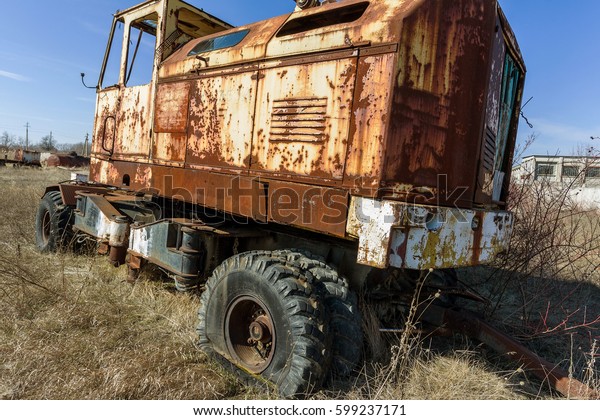 Old rusty truck thrown in desert of car park\
in ghost town of Pripyat, Chernobyl, Ukraine. Old rusty ancient\
car, Broken abandoned ancient rusty iron car. Radiation Zone\
Stalker, Apocalypse\
industrial