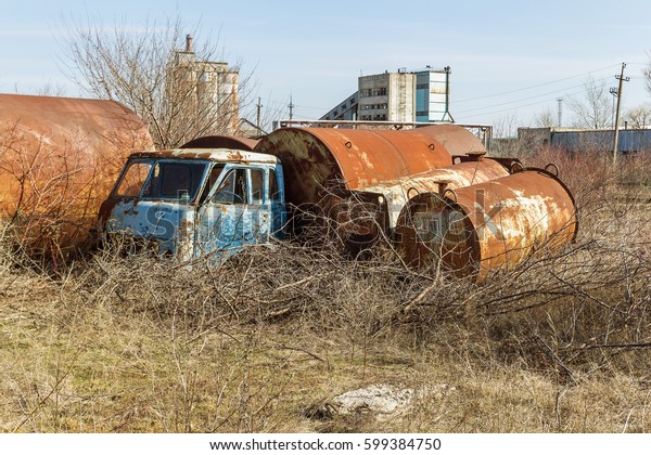 Old rusty truck thrown in desert of car park in\
ghost town of Pripyat, Chernobyl, Ukraine. Old rusty ancient car,\
Broken abandoned ancient rusty iron car. Radiation Zone, Stalker,\
Apocalypse Park USSR