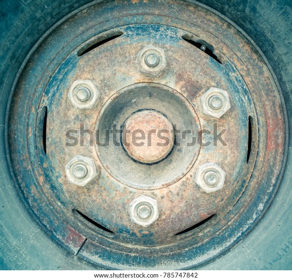 Old rusty truck wheel\
and rubber tire
