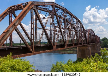 Old rusty truss railroad bridge over the Red River on the border of Texas and Oklahoma