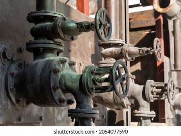 Old Rusty Valves Of Industrial Oven From Steam Revolution Times With Pipes All In Steampunk Climate