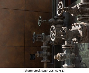 Old Rusty Valves Of Industrial Oven From Steam Revolution Times With Pipes All In Steampunk Climate