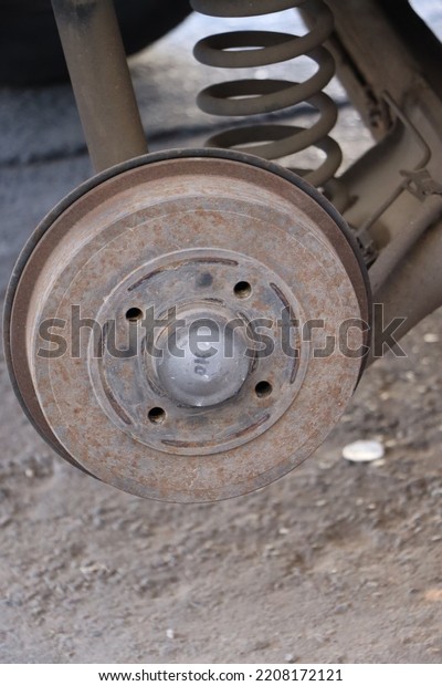 Old and rusty\
wheel discs rotor of a car .\
