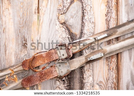 old rusty wooden cross-country skis on a wooden wall