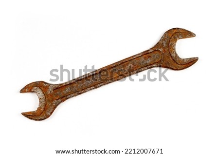 An old rusty wrench on a white background. Vintage wrench close-up.