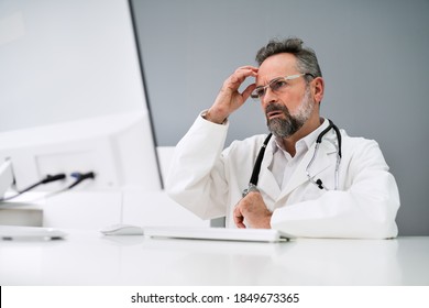 Old Sad Man Doctor Stress And Pain At Computer