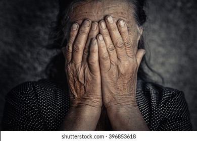 Old Sad Poor Woman. Closeup Portrait Depressed Stressed Thoughtful Senior Lady Elderly Gloomy Worried Covering Face Isolated Dark Background. Human Face Expressions Emotions Feelings Reaction Attitude