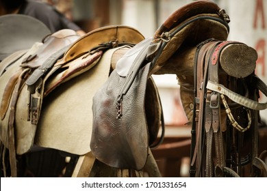 Old Saddle Hanging On A Log