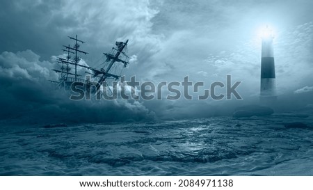 An old sailing ship in the mist sails towards the rocks with amazing lighthouse - Sailing old ship in a storm sea in the background stormy clouds
